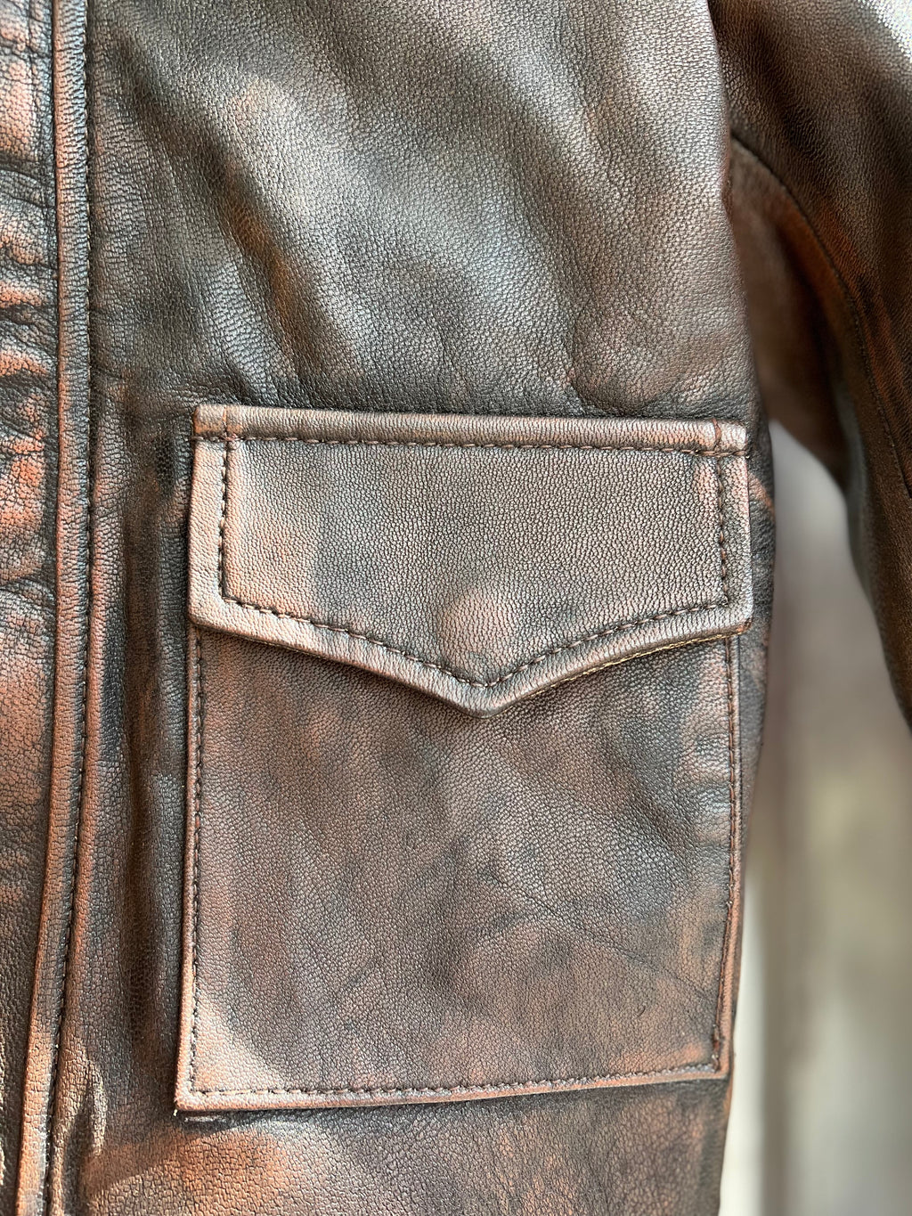Kids Indiana Jones distressed leather jacket front pocket close-up – toddler brown real leather adventure jacket