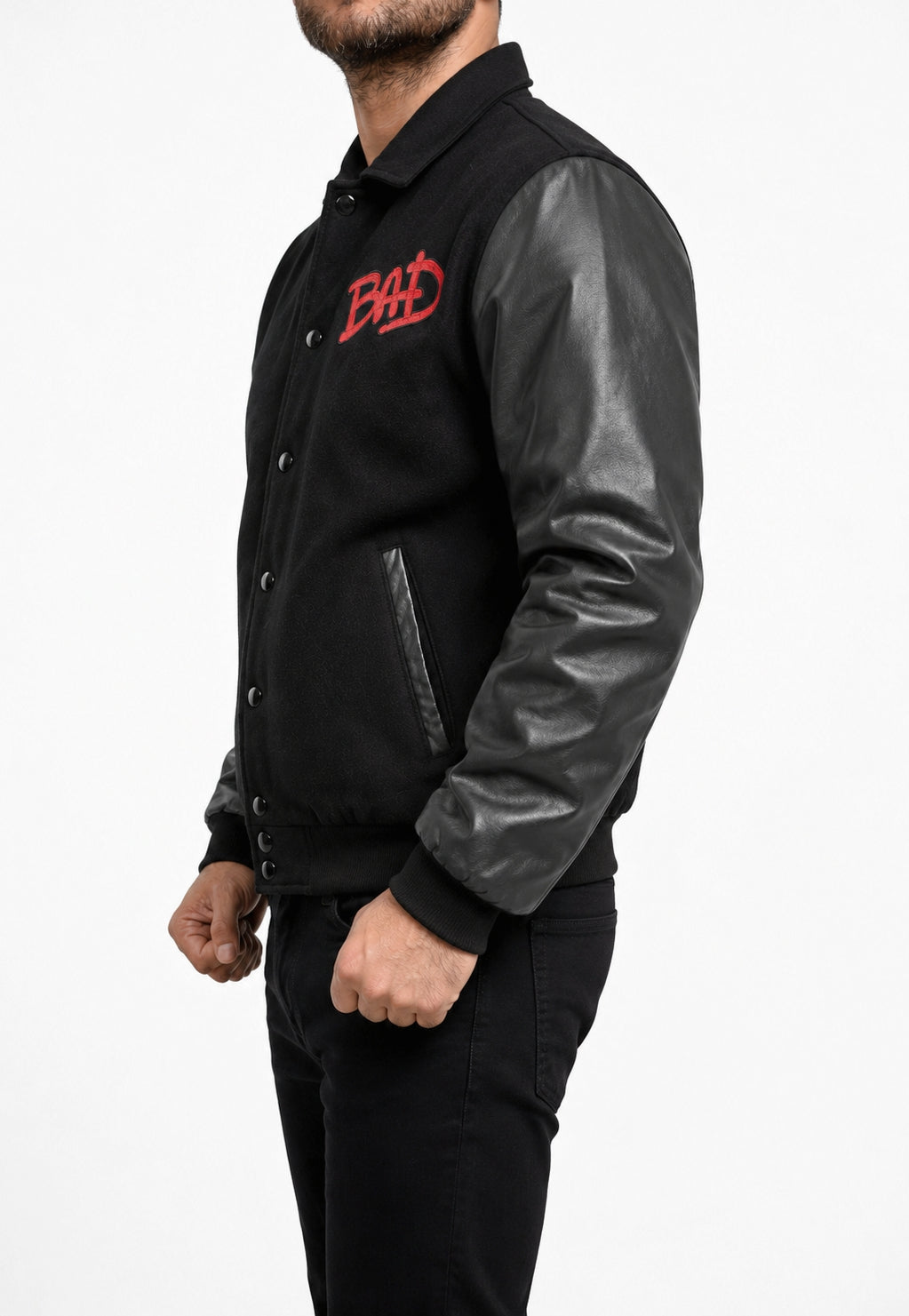 Michael Jackson MJ Bad Bomber Wool Jacket side view with black wool body, leather sleeves, front BAD embroidery, snap buttons, and ribbed cuffs